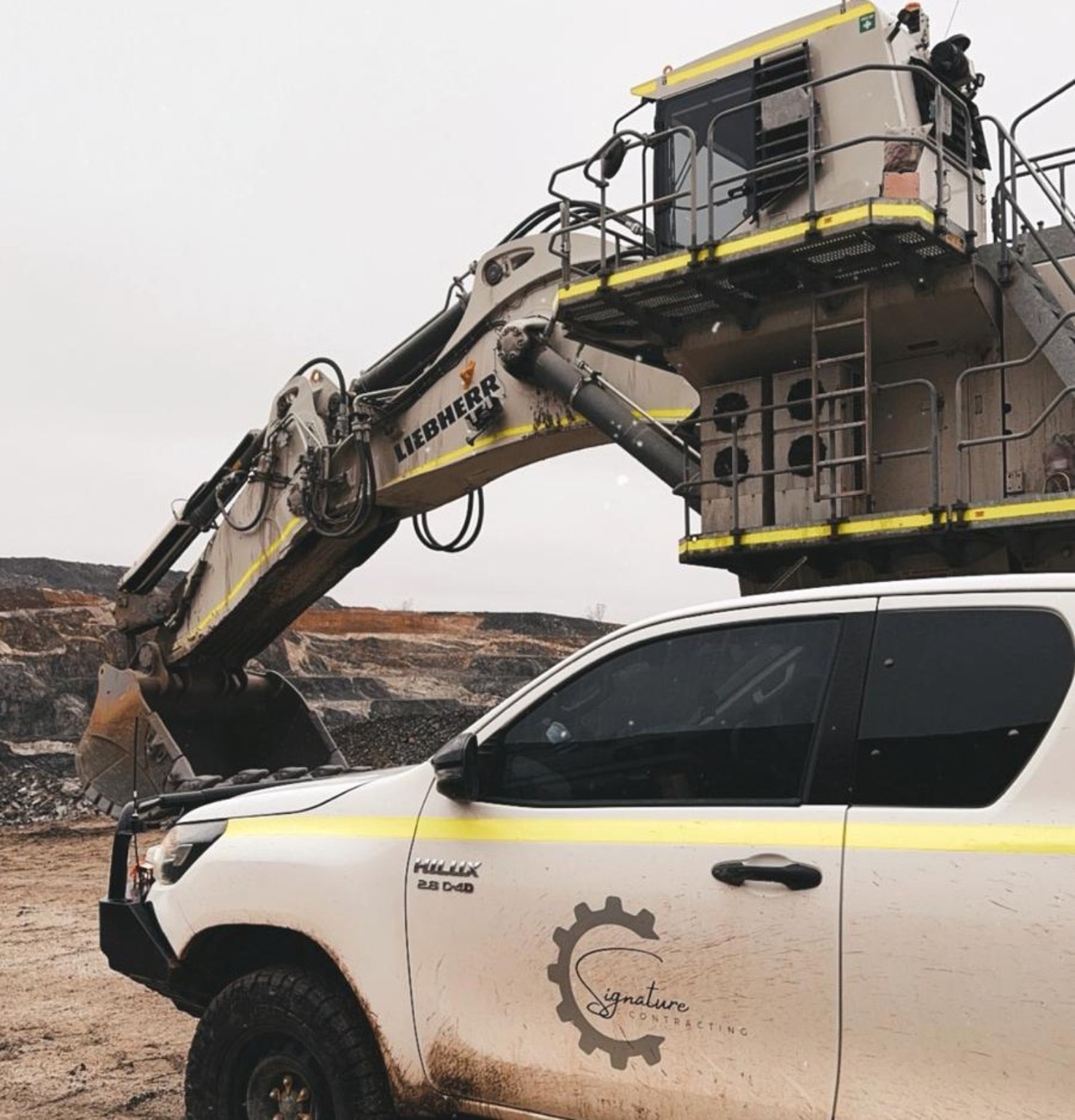 Signature Contracting ute beside Liebherr excavator